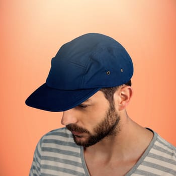 Thoughtful young man looking down over white background against red background