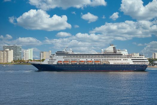 A large blue and white cruise ship in a harbor