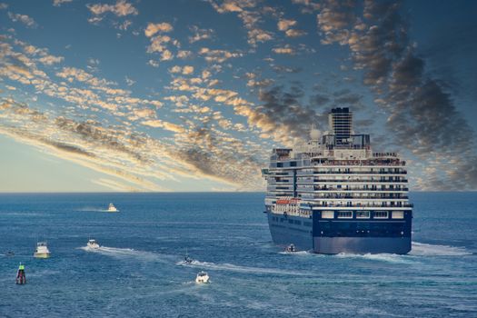 A blue and white cruise ship sailing out to sea