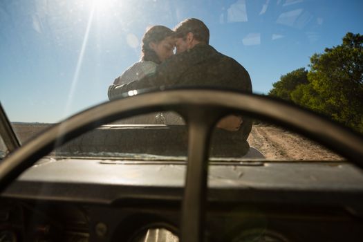 Romantic couple seen through off road vehicle windshield on sunny day