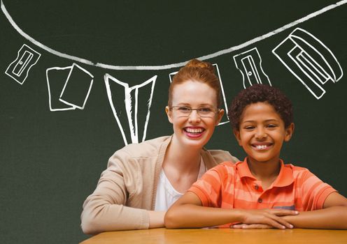 Digital composite of Student boy and teacher at table smiling against green blackboard with school and education graphic