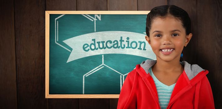 Portrait of smiling girl holding digital tablet against education against green chalkboard