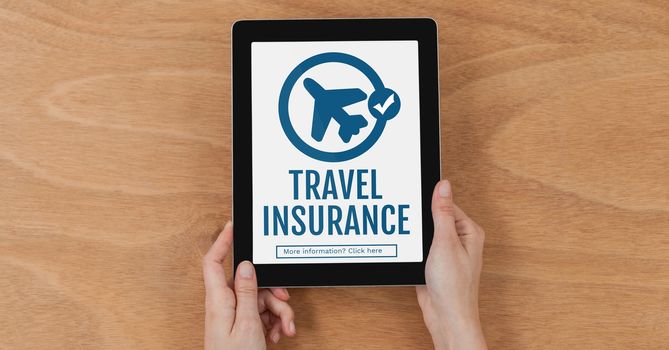 Digital composite of Person holding a tablet with travel insurance concept on screen