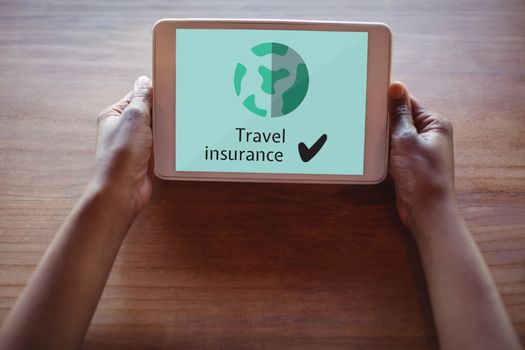 Digital composite of Person holding a tablet with travel insurance concept on screen