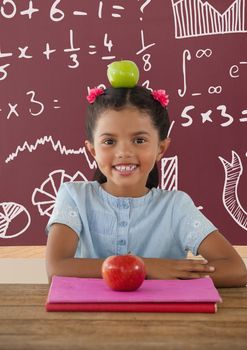 Digital composite of Student girl at table against red blackboard with education and school graphics