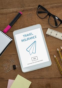 Digital composite of Tablet with travel insurance concept on screen
