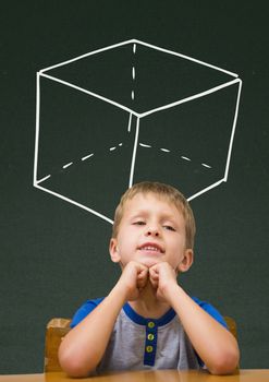 Digital composite of Student boy at table against green blackboard with school and education graphic