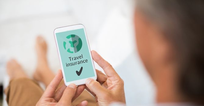 Digital composite of Man holding a phone with travel insurance concept on screen