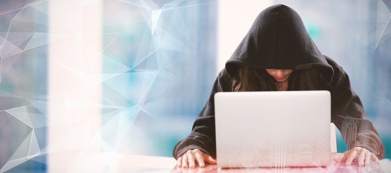 Female hacker sitting by laptop on table  against abstract glowing black background