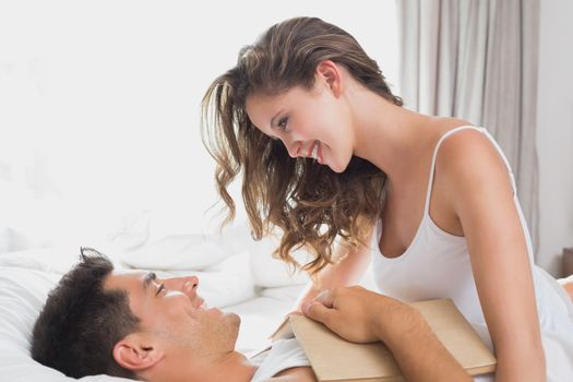 Side view of romantic young couple in bed at home