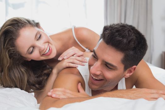 Close up portrait of romantic young couple in bed at home