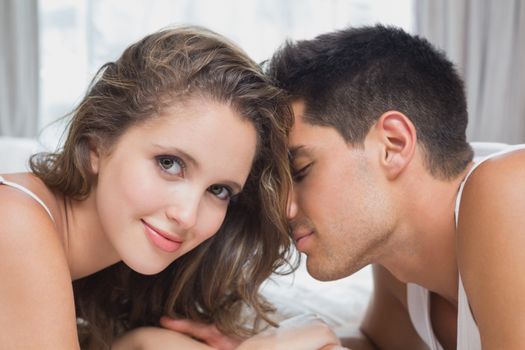 Close up side view of romantic young couple in bed at home