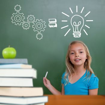 Green apple on pile of books against cute pupil holding chalk