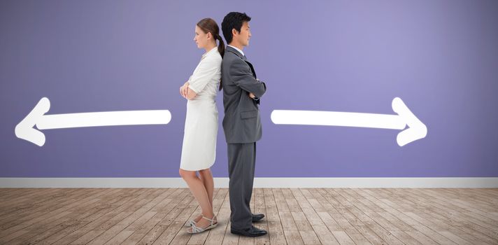 Portrait of serious business people standing back-to-back against room with wooden floor