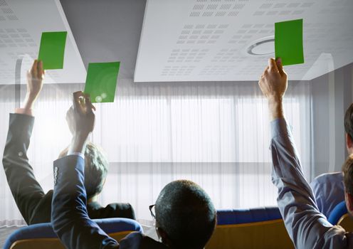 Digital composite of Business people holding green cards at conference by windows