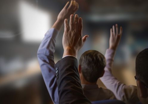 Digital composite of Business people with hands raised up at conference