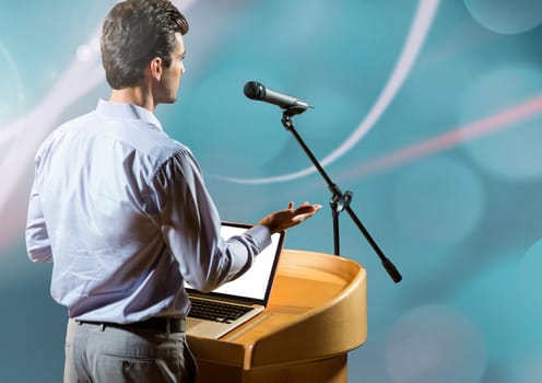 Digital composite of Businessman on podium speaking at conference with abstract background