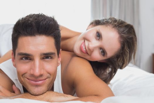 Close up portrait of romantic young couple in bed at home