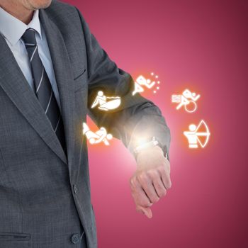 Mid section of businessman checking smart watch against red and white background