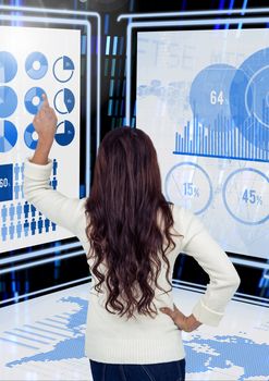 Digital composite of Businesswoman touching and interacting with technology interface panels