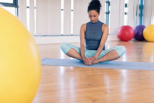 Young woman performing yoga in the gym