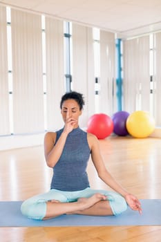 Beautiful woman performing yoga in gym