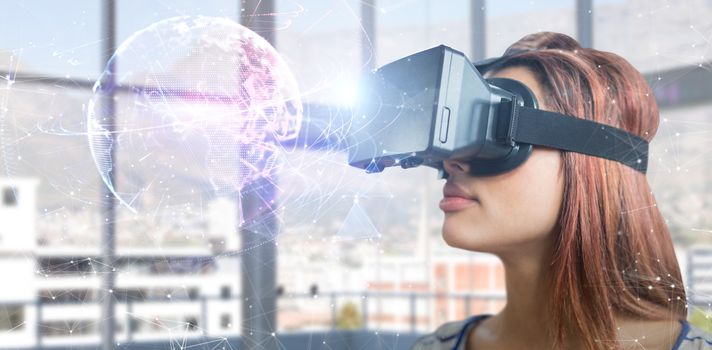 Close up of young woman using virtual reality simulator against global technology background in blue