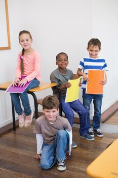 Classmates smiling together in classroom at the elementary school