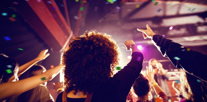 Flying colours against people enjoying music concert at nightclub