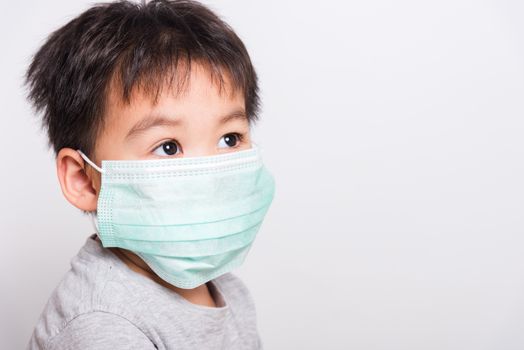 Closeup Asian face, Little children boy sick he using medicine healthcare mask on white background with copy space, health medical care