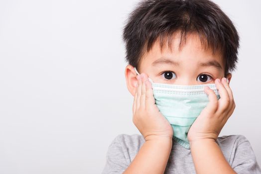 Closeup Asian face, Little children boy sick he using medicine healthcare mask on white background with copy space, health medical care