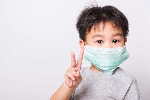 Closeup Asian face, Little children boy sick he using medicine healthcare mask on white background with copy space, health medical care