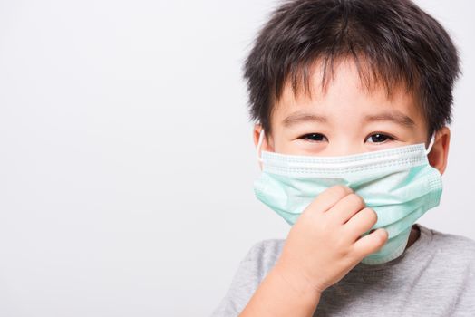 Closeup Asian face, Little children boy sick he using medicine healthcare mask on white background with copy space, health medical care