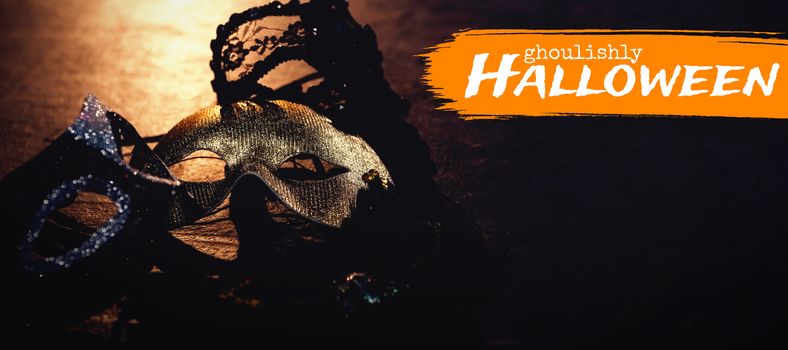 Graphic image of ghoulishly Halloween text against masks on stage