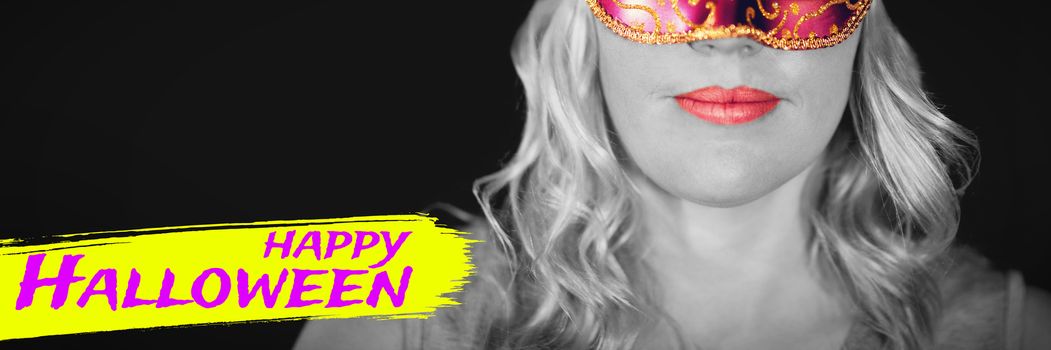 Digital image of happy Halloween text against portrait of woman in masquerade mask 