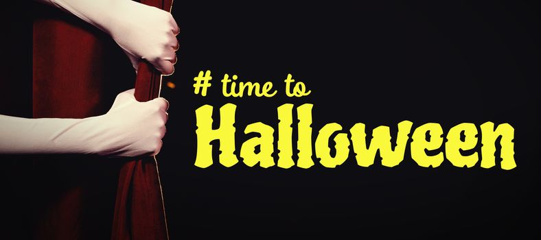 Digital image of time to Halloween text against cropped hands in gloves holding curtain at stage