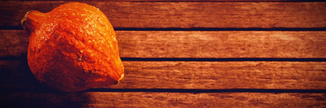 Overhead view of squash on wooden table during Halloween