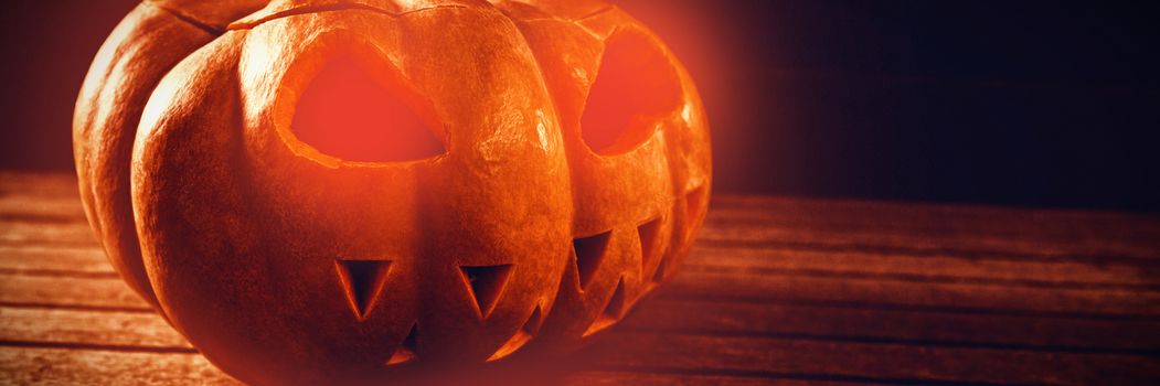 Close up of jack o lantern on wooden table during Halloween