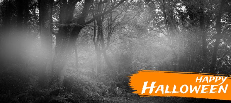 Digital image of happy Halloween text against way between trees