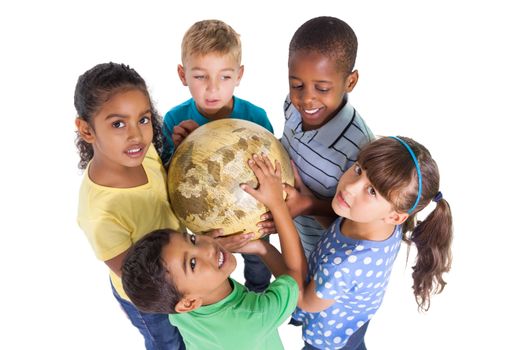 Cute schoolchildren smiling at camera holding globe on white background