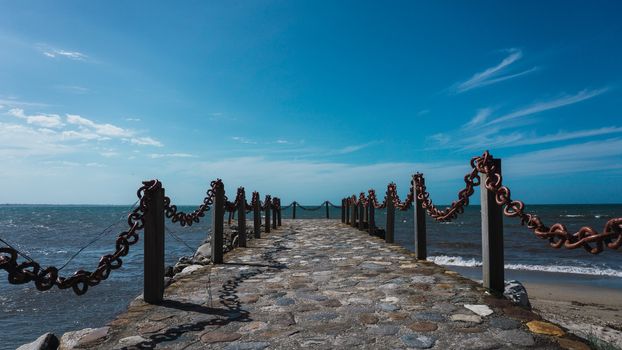 Beautiful view on the pier with a blue sky and ocean