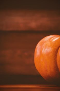 Cropped image of pumpkin on wooden table during Halloween