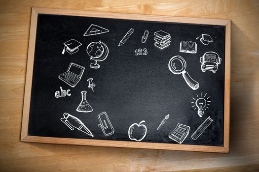 Composite image of education doodles against chalkboard