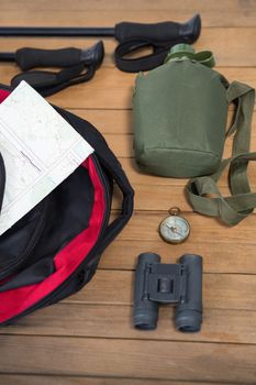 Close-up of various travel equipment on wooden floor