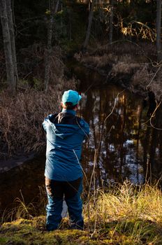 Fisherman angler  fishing forest river blue costume try catch trout