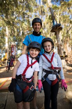 Happy kids and instructor standing together in park