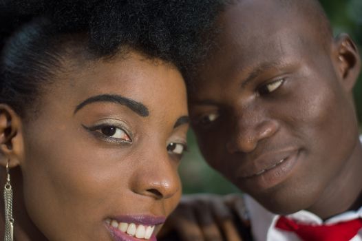 Close-up of faces of young couple in love with heads stuck against each other.