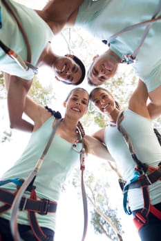 Portrait of fit friends forming huddle in park