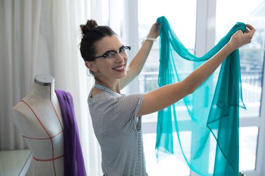 Fashion designer designing a fabric textile at home