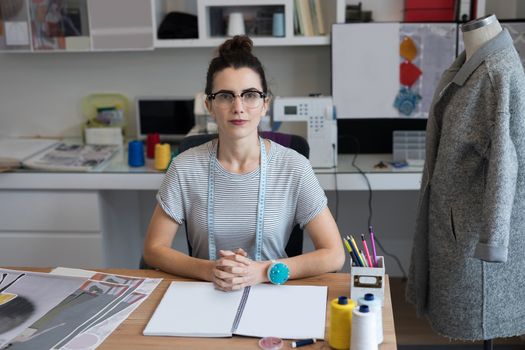 Young fashion designer working at desk